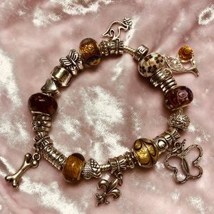 Charm bracelet with charms that is silver.
